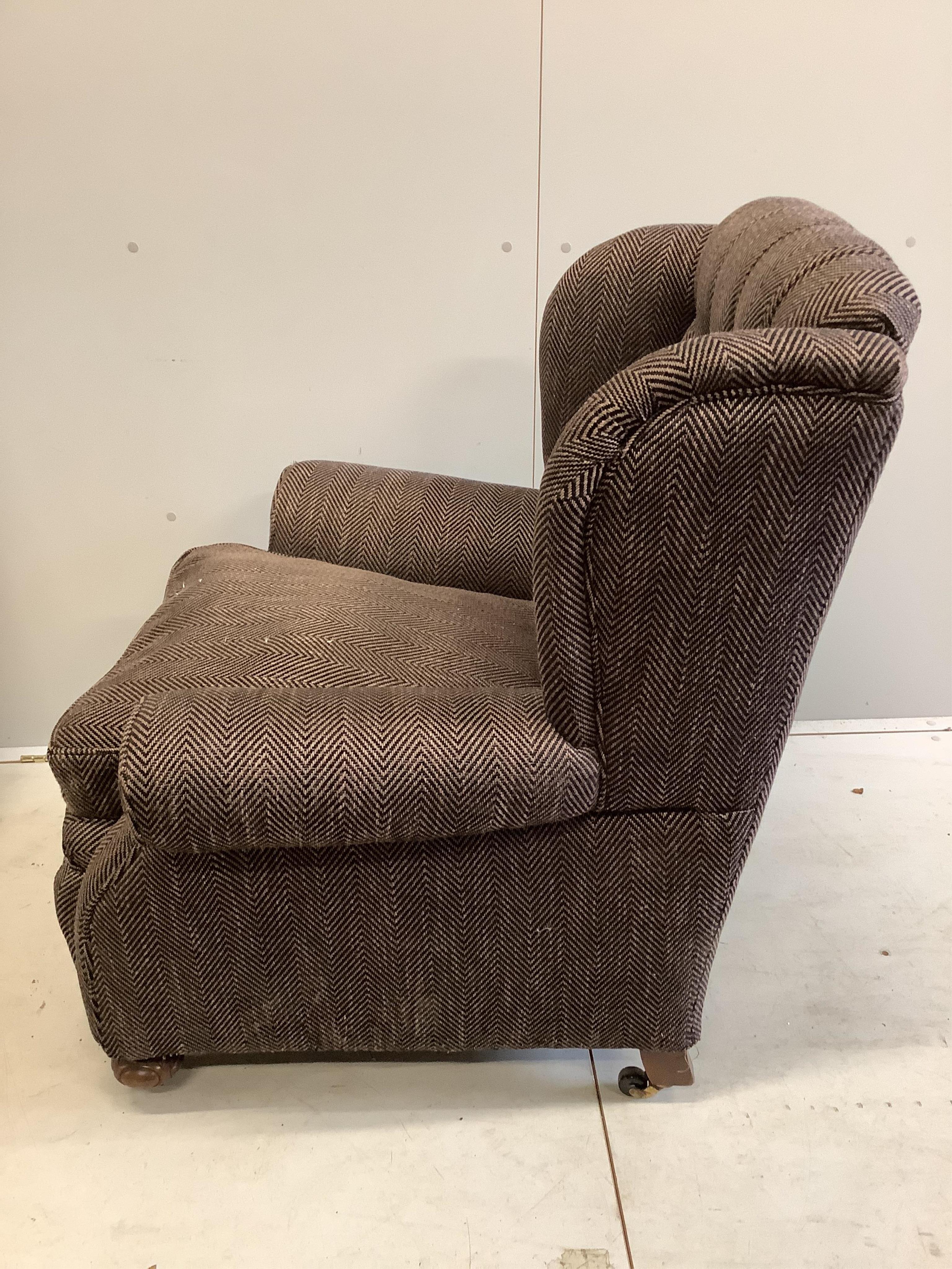 A near pair of early 20th century upholstered armchairs, recently upholstered, larger width 92cm, depth 90cm, height 98cm, together with a spare roll of upholstery fabric. Condition - good